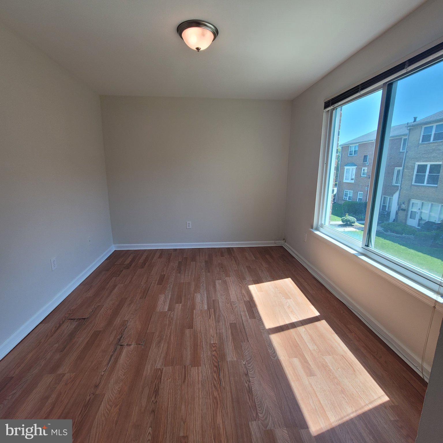 1833 Addison Road South District Heights, MD 20747 - Photo 13 of 14 a view of wooden floor and windows in a room