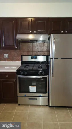 a stove top oven sitting inside of a kitchen