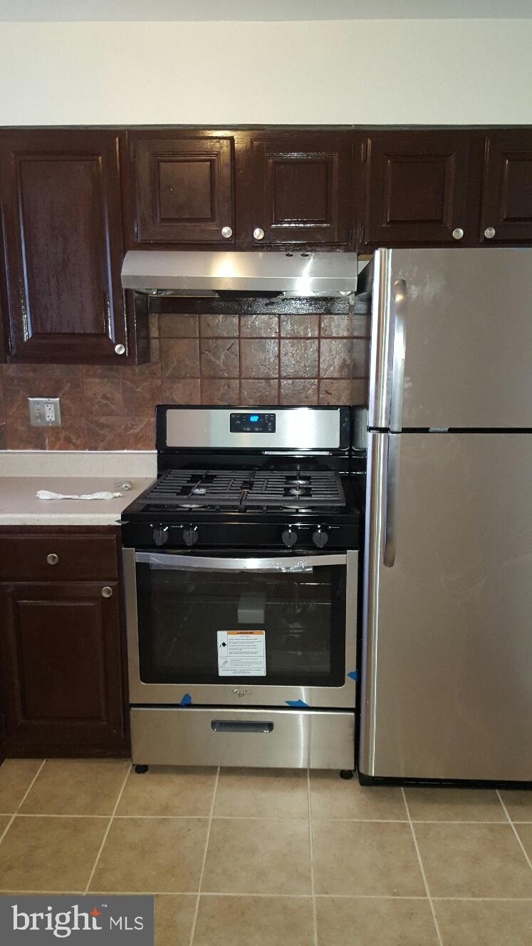1833 Addison Road South District Heights, MD 20747 - Photo 2 of 10 a stove top oven sitting inside of a kitchen