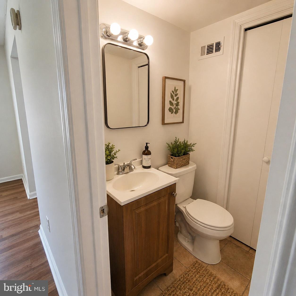 1833 Addison Road South District Heights, MD 20747 - Photo 7 of 14 a bathroom with a toilet a sink and a mirror