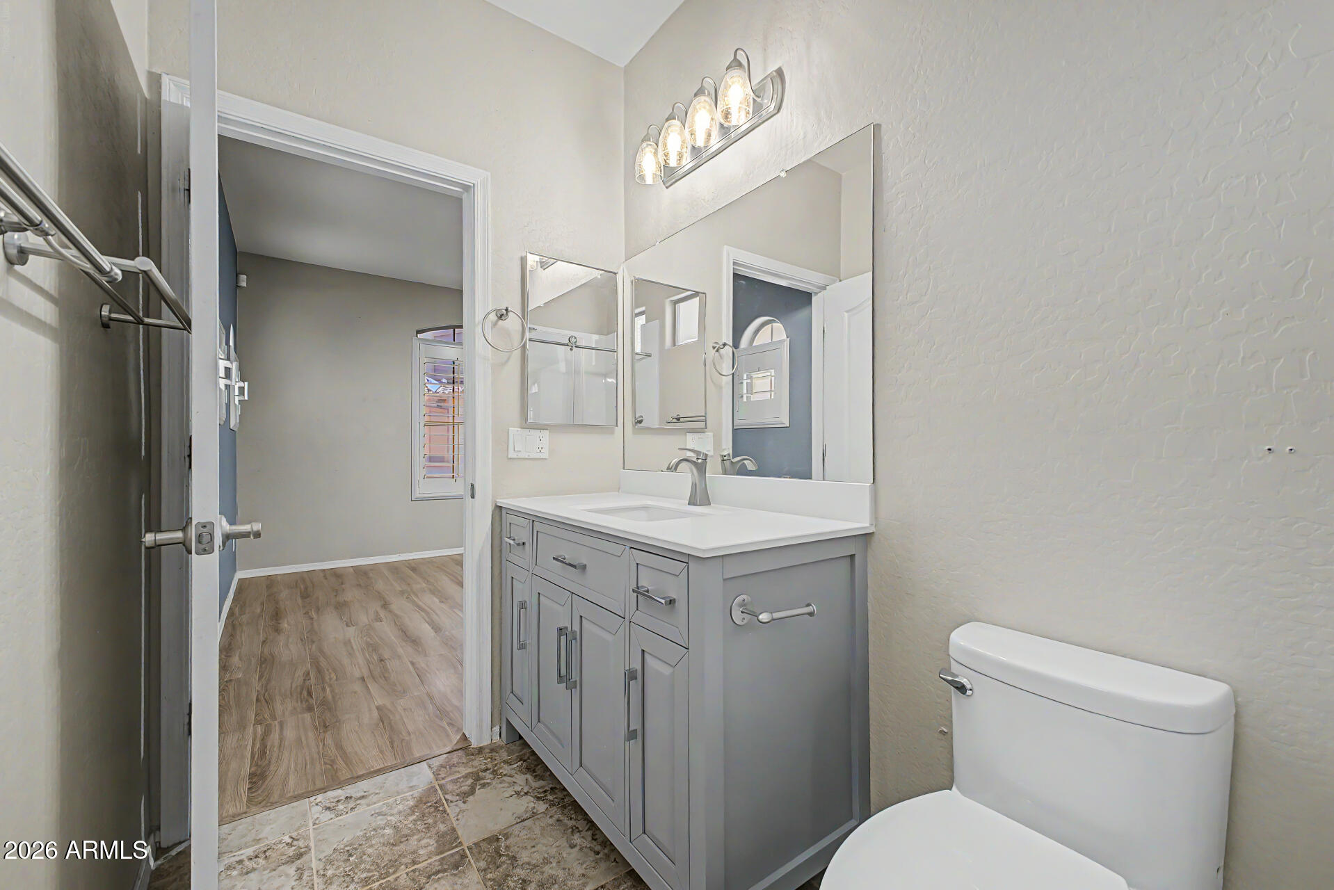 2600 East Springfield Place, Unit 109 Chandler, AZ 85286 - Photo 16 of 38 a bathroom with a sink a toilet and a mirror