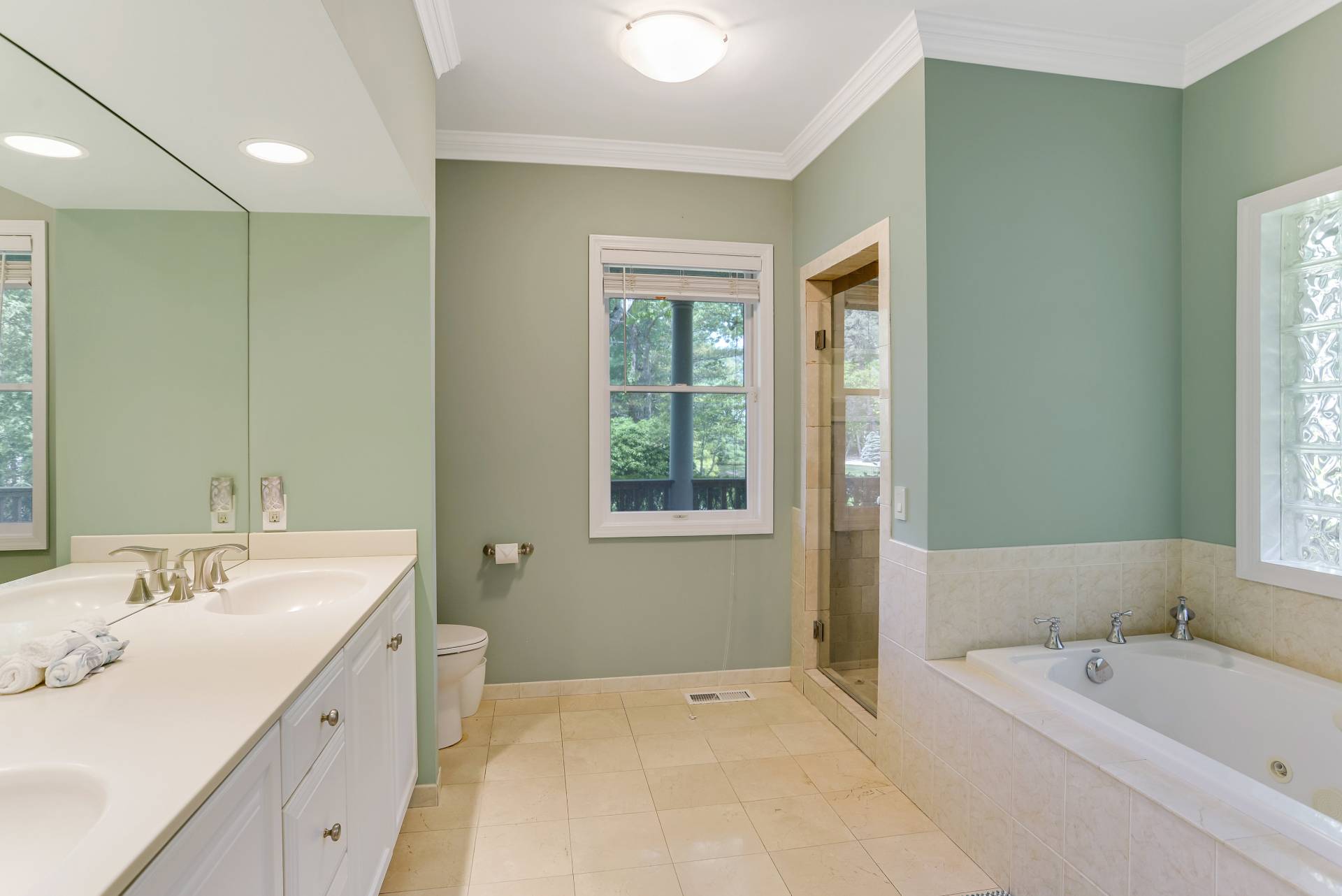 49 Bridle Path Westhampton Beach, NY 11978 - Photo 14 of 37 a spacious bathroom with a tub sink and mirror