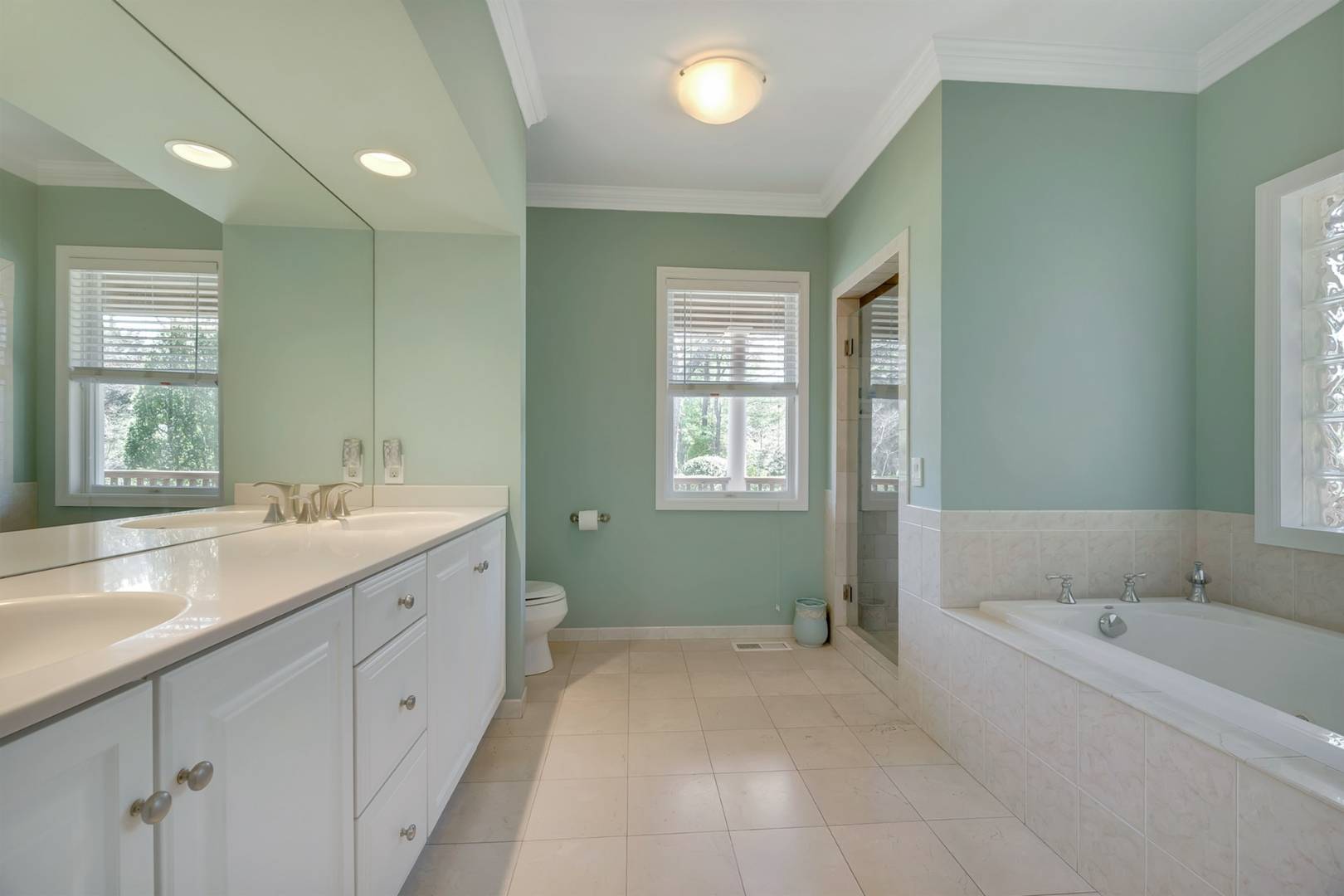 49 Bridle Path Westhampton Beach, NY 11978 - Photo 17 of 37 a spacious bathroom with double vanity sink a mirror and a bathtub