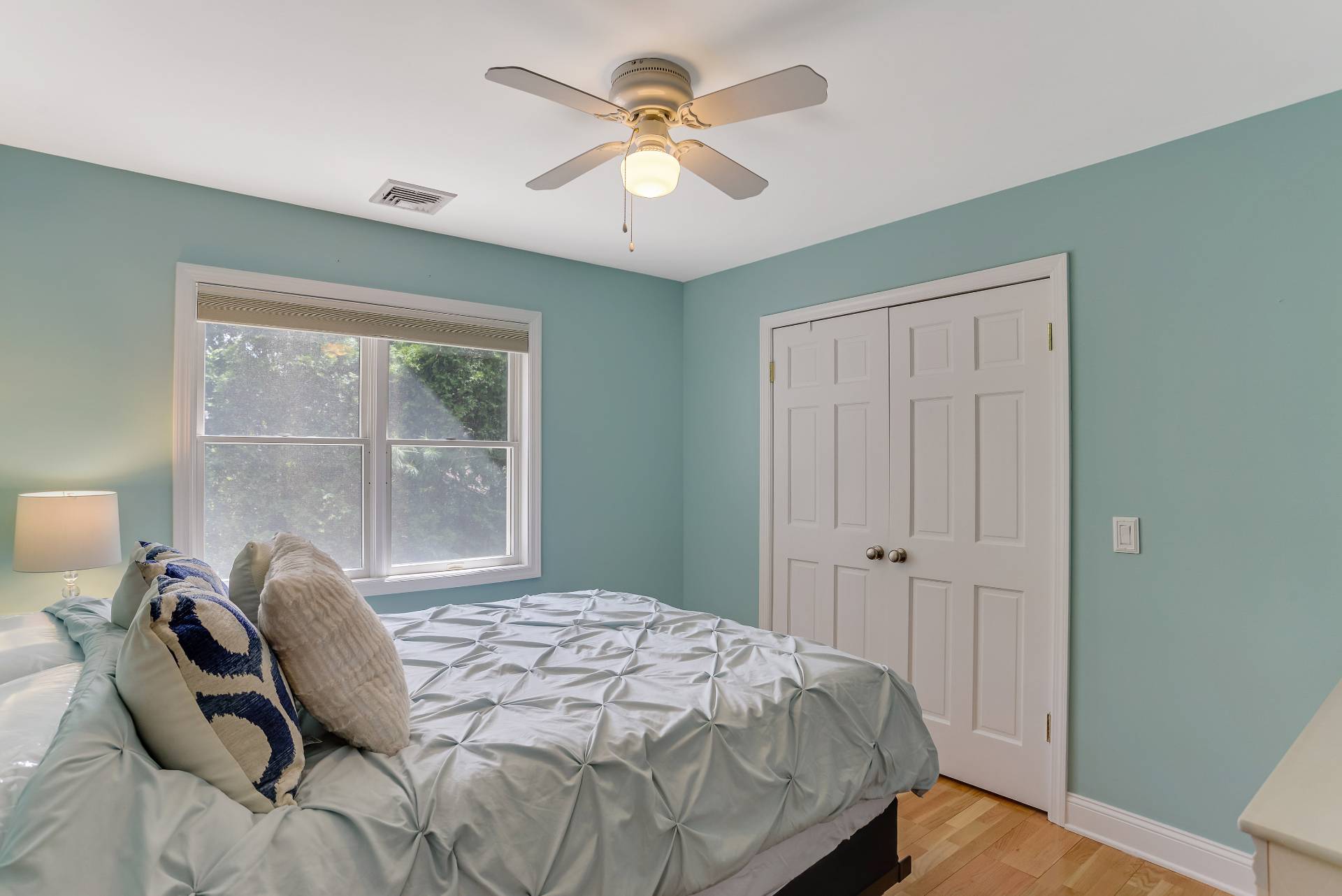 49 Bridle Path Westhampton Beach, NY 11978 - Photo 20 of 37 a bedroom with a bed and a chandelier