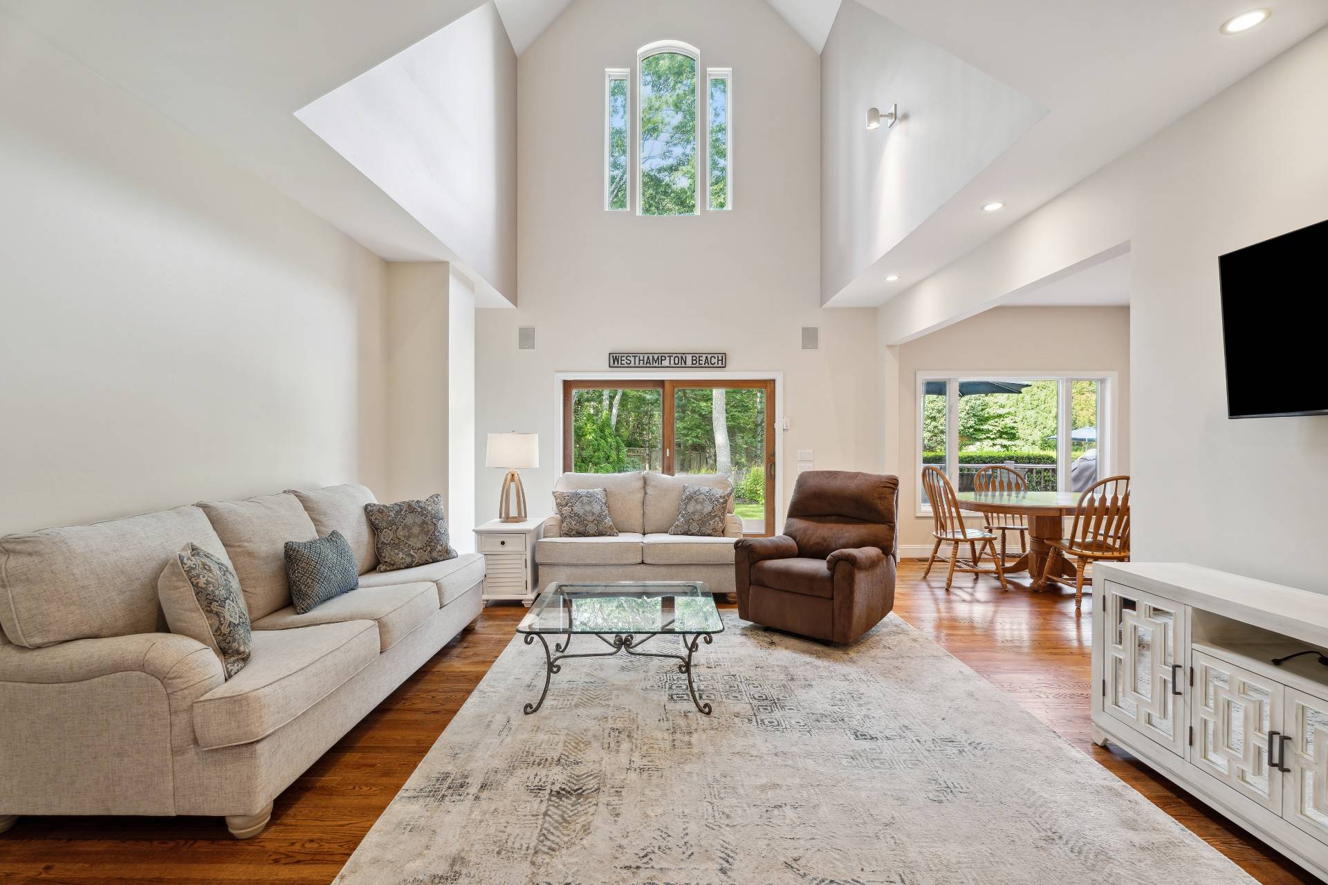49 Bridle Path Westhampton Beach, NY 11978 - Photo 3 of 37 a living room with furniture fireplace and a flat screen tv