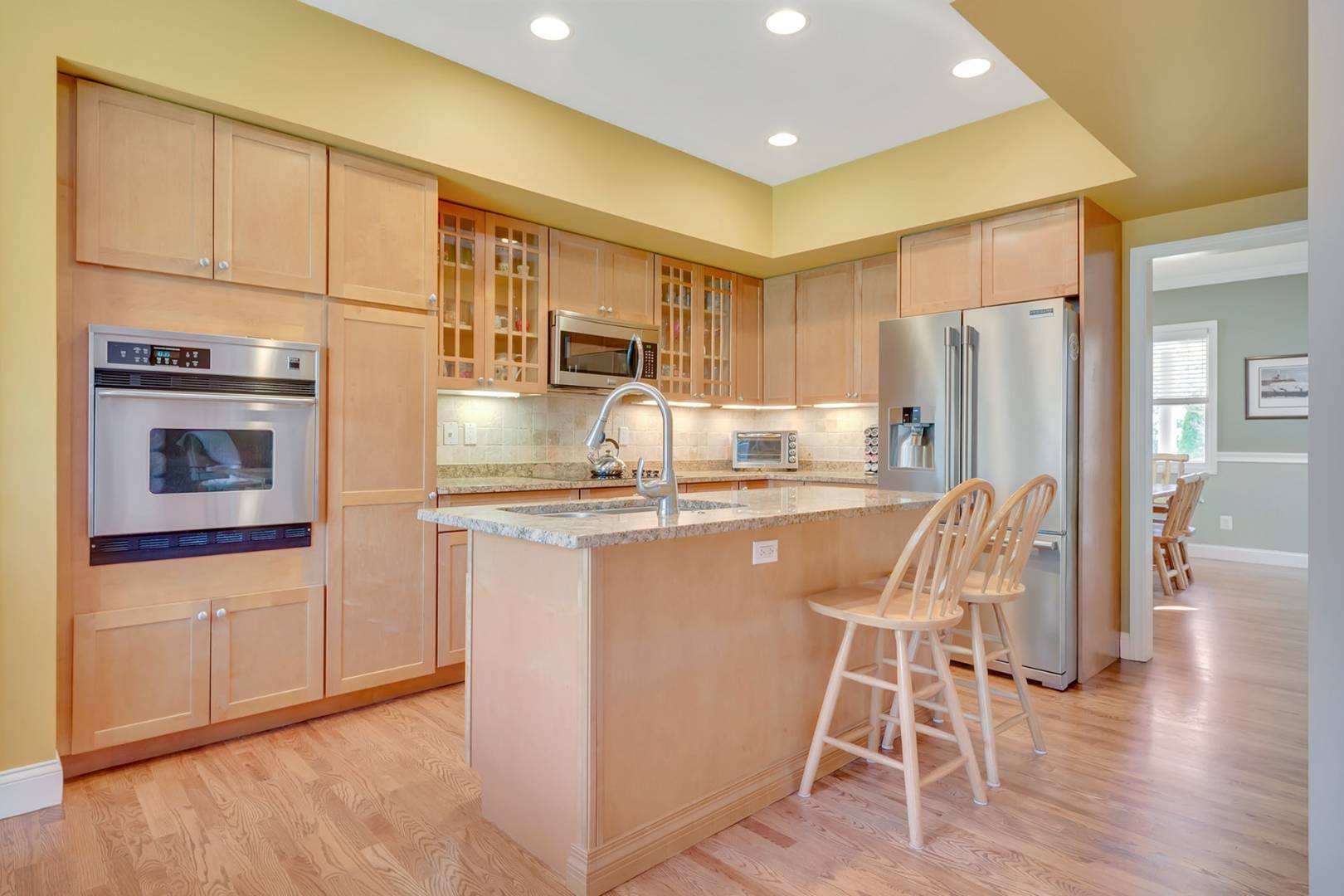 49 Bridle Path Westhampton Beach, NY 11978 - Photo 9 of 37 a kitchen with stainless steel appliances granite countertop a refrigerator and microwave