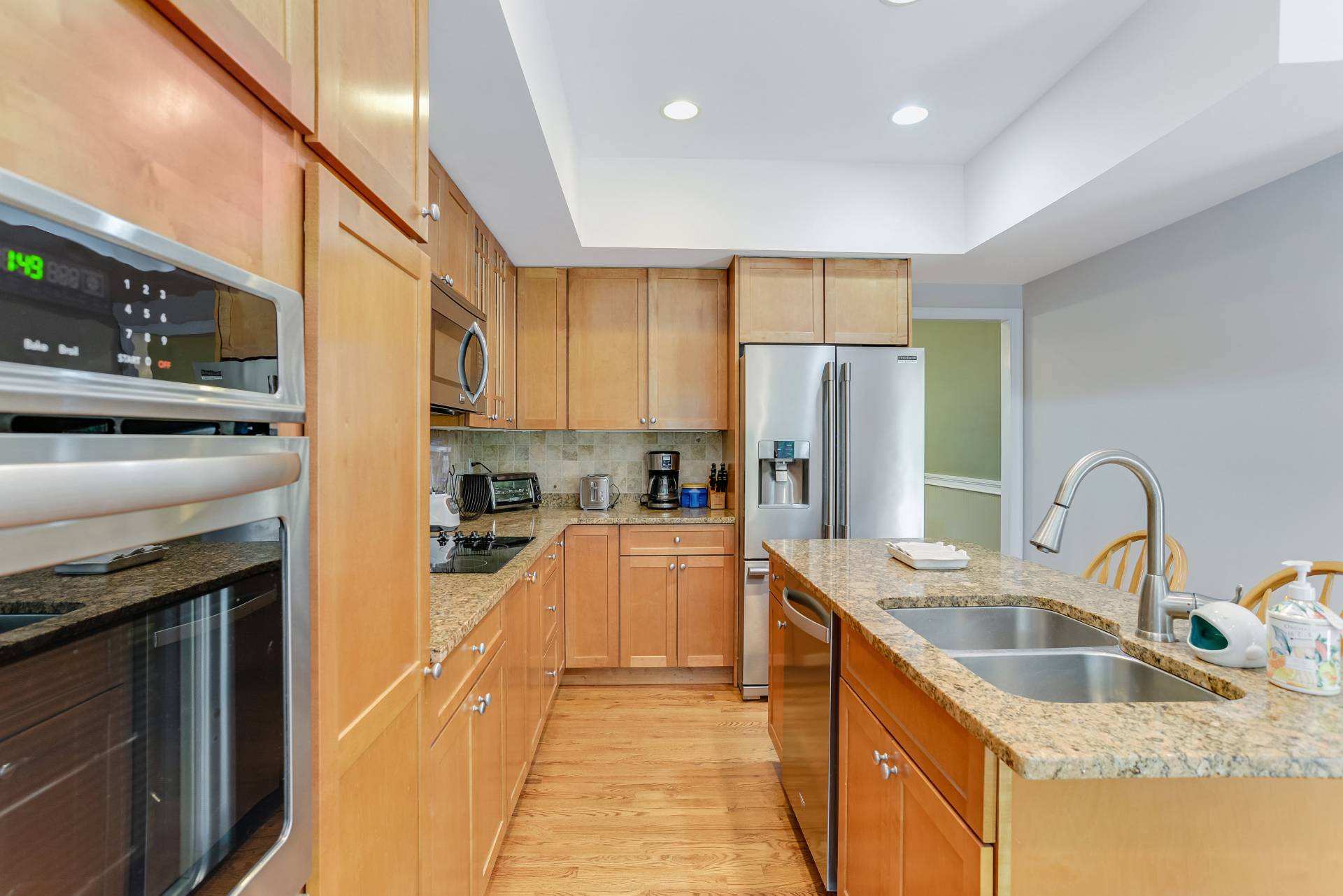 49 Bridle Path Westhampton Beach, NY 11978 - Photo 10 of 37 a kitchen with stainless steel appliances granite countertop a sink refrigerator and cabinets