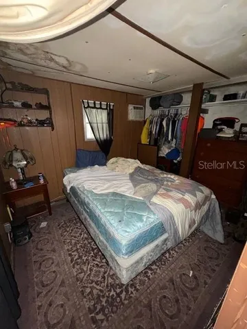 a bed sitting in a bedroom next to a window