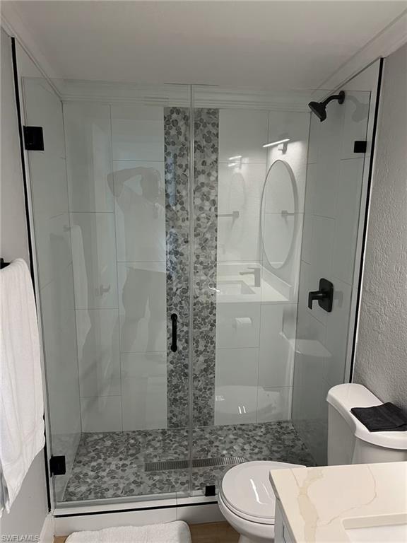 1220 Embassy Lane Naples, FL 34104 - Photo 2 of 11 a bathroom with a toilet and a shower