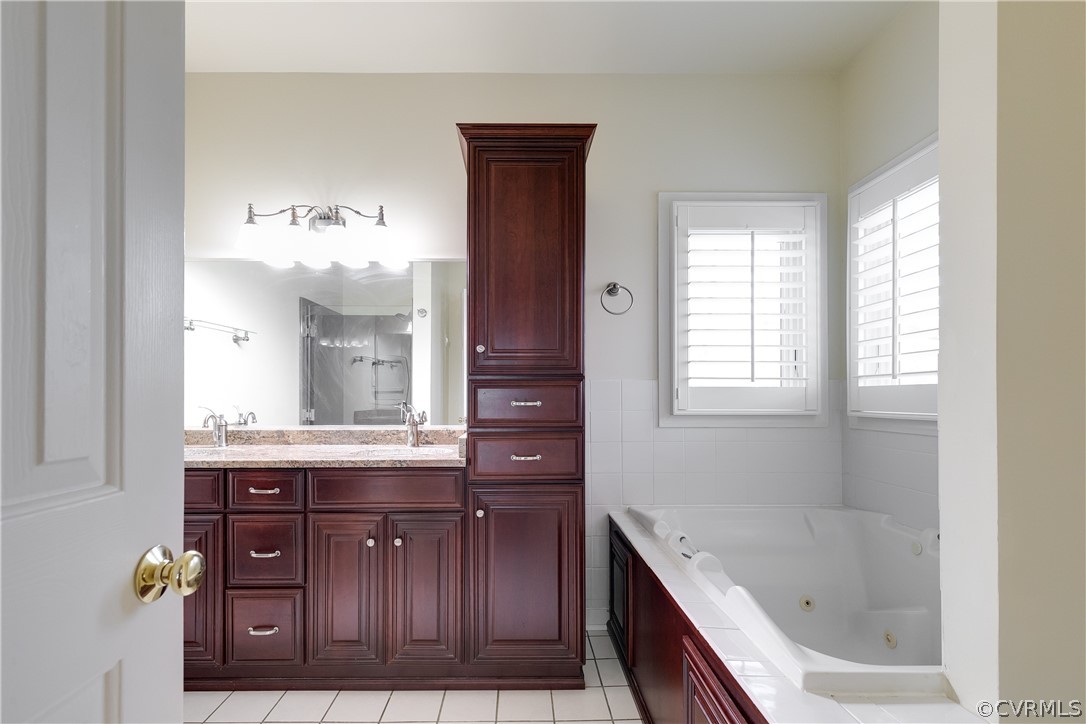 1931 Thornleigh Road Midlothian, VA 23113 - Photo 24 of 46 a bathroom with a granite countertop bathtub a sink and a window