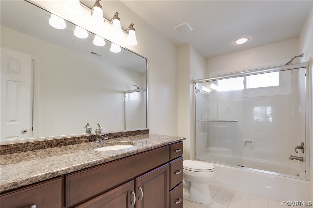 1931 Thornleigh Road Midlothian, VA 23113 - Photo 28 of 46 a bathroom with a granite countertop sink a toilet a mirror and bathtub