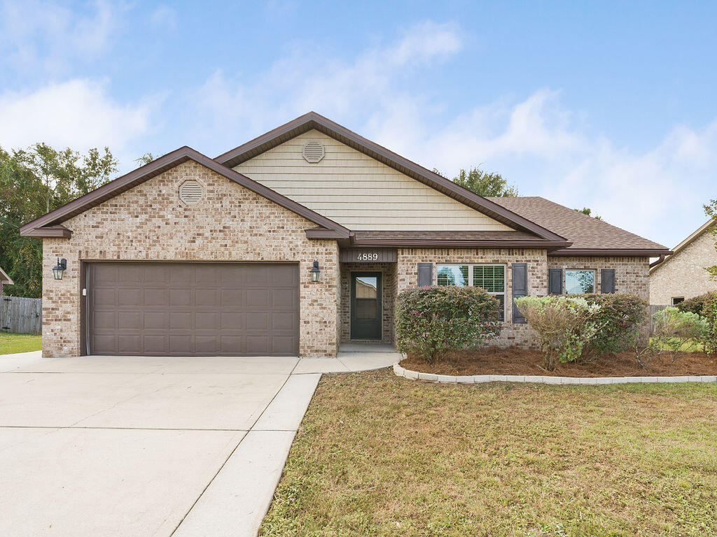 4889 Spears Street Pace, FL 32571 - Photo 1 of 25 a front view of small house with yard