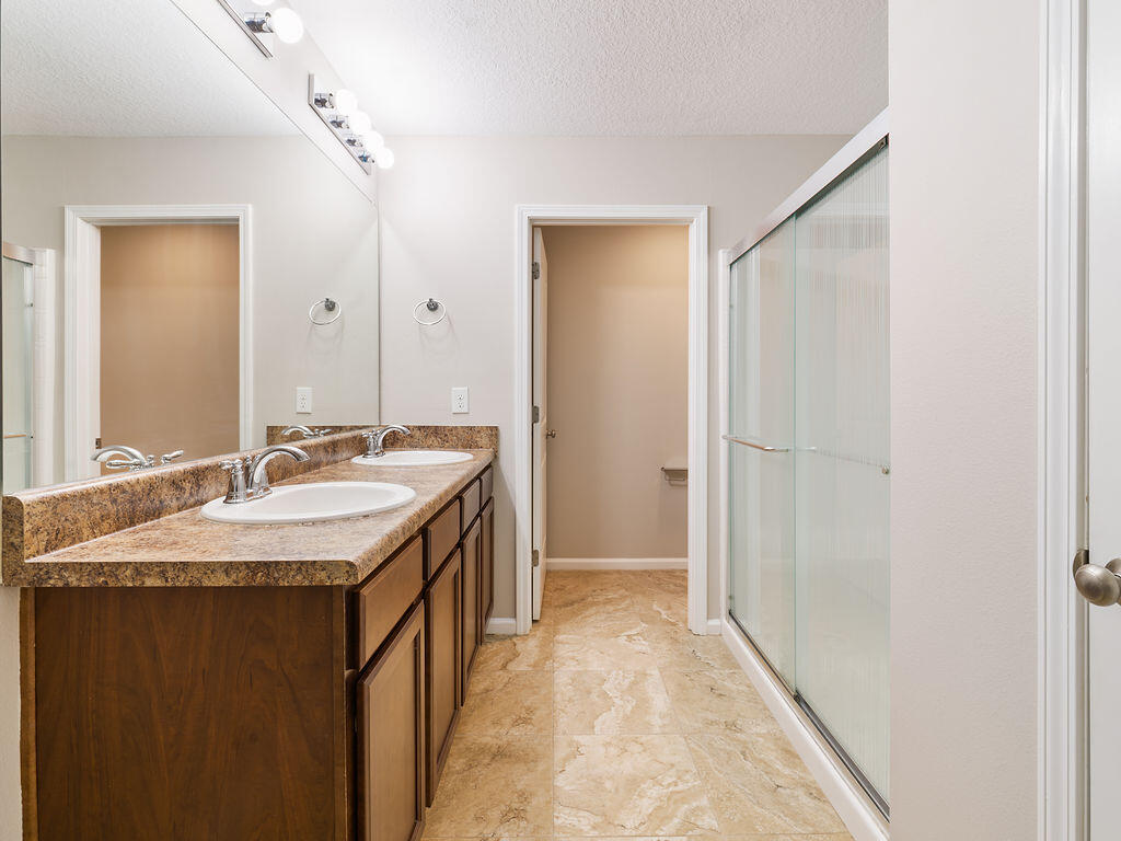 4889 Spears Street Pace, FL 32571 - Photo 14 of 25 a bathroom with a granite countertop sink and a mirror