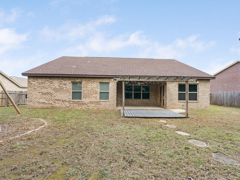 4889 Spears Street Pace, FL 32571 - Photo 23 of 25 a front view of a house with a garden