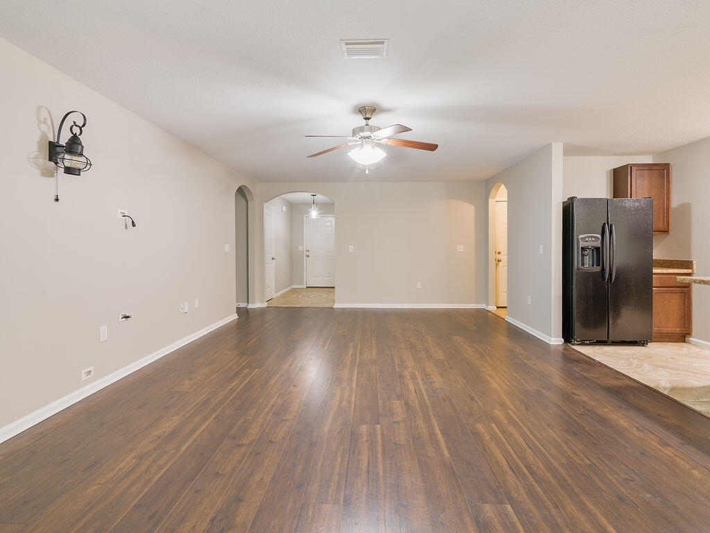 4889 Spears Street Pace, FL 32571 - Photo 7 of 25 a view of a livingroom with a ceiling fan and hardwood floor