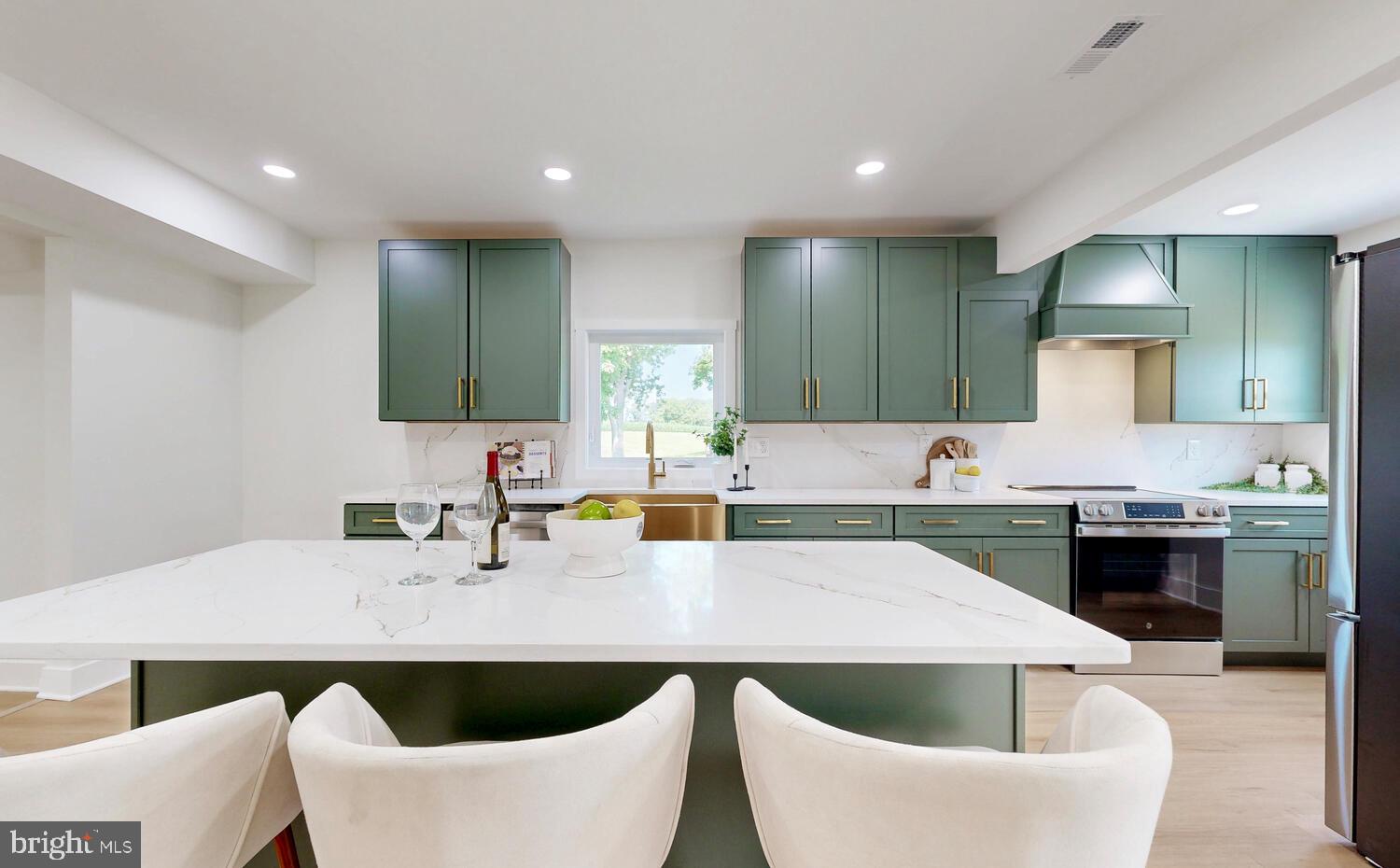 4414 Mt Carmel Road Hampstead, MD 21074 - Photo 14 of 40 a kitchen with a table chairs sink and cabinets
