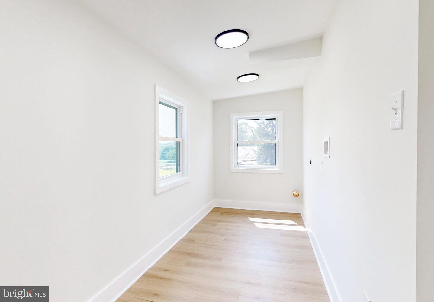 4414 Mt Carmel Road Hampstead, MD 21074 - Photo 30 of 40 a view of an empty room with wooden floor and a window