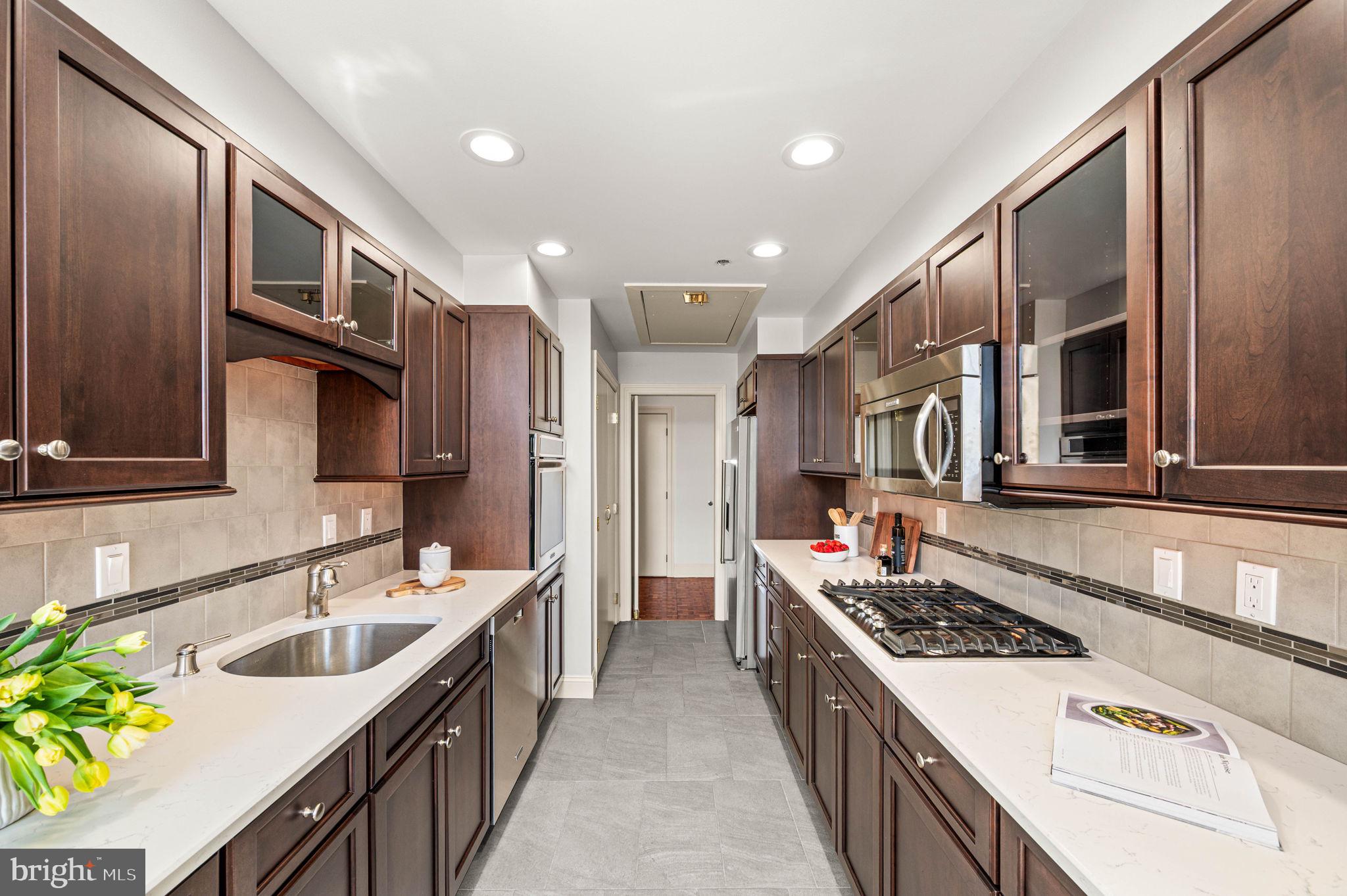 211 South 4th Street, Unit 301 Philadelphia, PA 19106 - Photo 15 of 42 a large kitchen with a stove and a sink