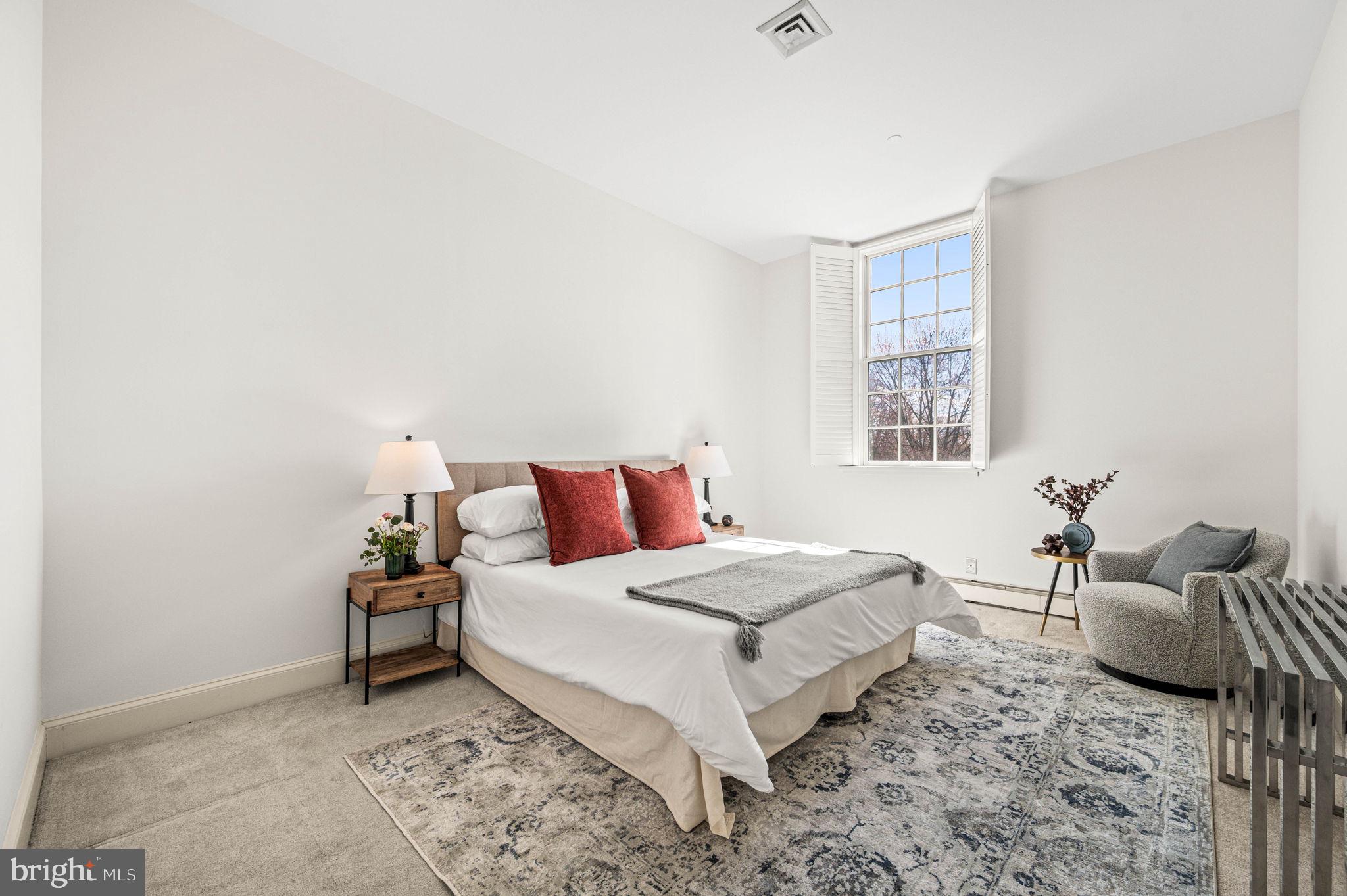 211 South 4th Street, Unit 301 Philadelphia, PA 19106 - Photo 22 of 42 a bedroom with a bed and wooden floor