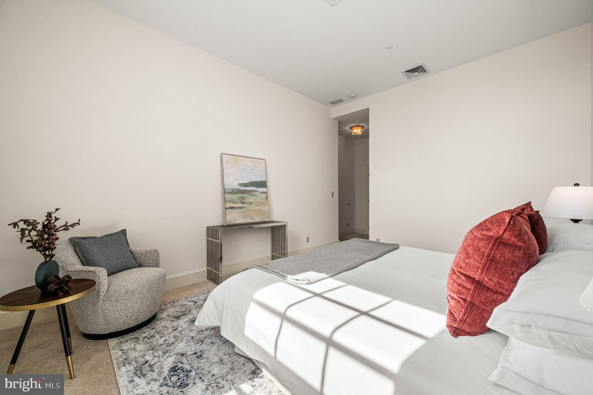 211 South 4th Street, Unit 301 Philadelphia, PA 19106 - Photo 25 of 42 a bedroom with a bed and chair