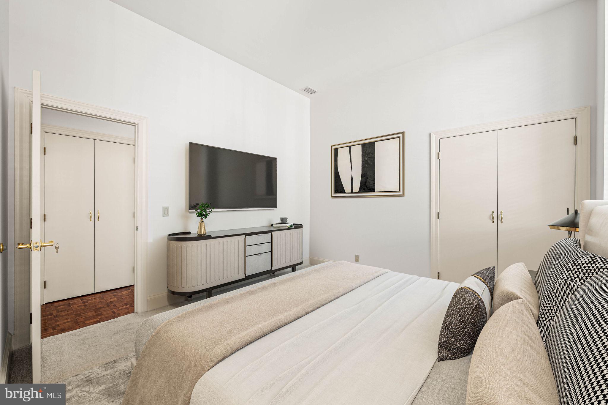 211 South 4th Street, Unit 301 Philadelphia, PA 19106 - Photo 30 of 42 a bedroom with a bed and a flat screen tv
