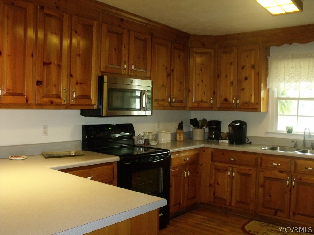 9811 Taylor Road Chesterfield, VA 23838 - Photo 13 of 24 a kitchen with granite countertop wooden cabinets and a stove top oven