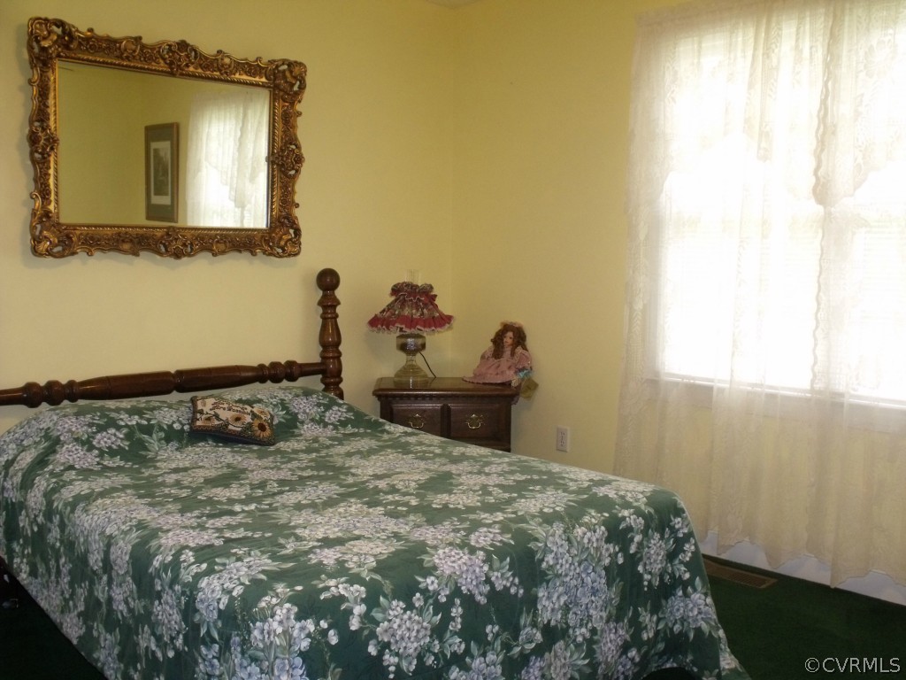 9811 Taylor Road Chesterfield, VA 23838 - Photo 7 of 24 a bedroom with a bed and a mirror