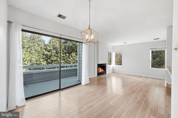 a view of a room with window wooden floor and front door