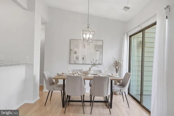 a view of a dining room with furniture window and wooden floor