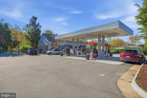 a patio with table and chairs and potted plants