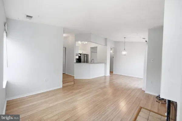 a view of a kitchen with wooden floor and a kitchen