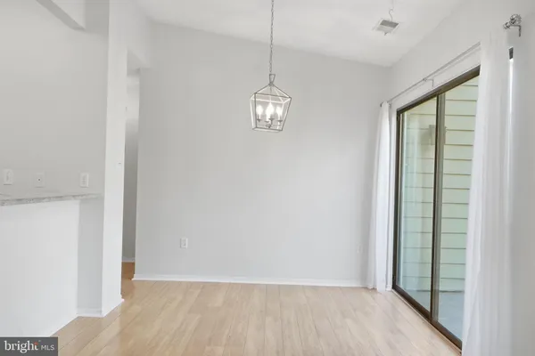 a view of a room with wooden floor and windows