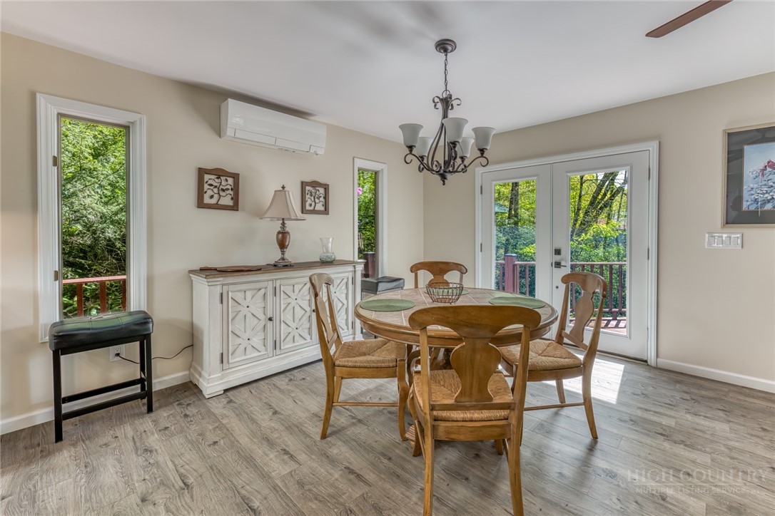 174 Spruce Pine Road Newland, NC 28657 - Photo 7 of 50 a view of a dining room with furniture window and wooden floor