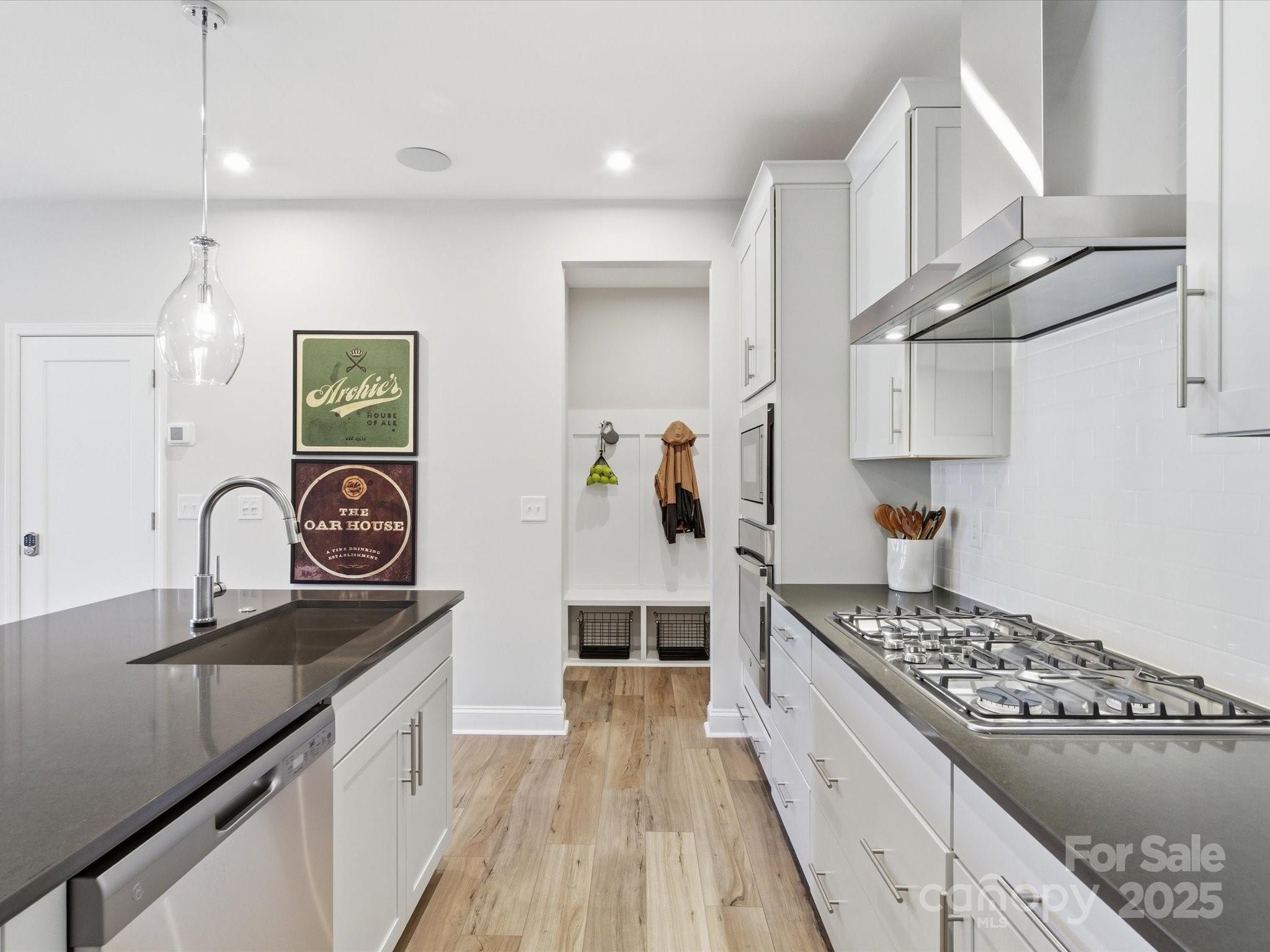 492 Nash Street Fort Mill, SC 29715 - Photo 12 of 28 a kitchen with stainless steel appliances granite countertop a sink stove and cabinets