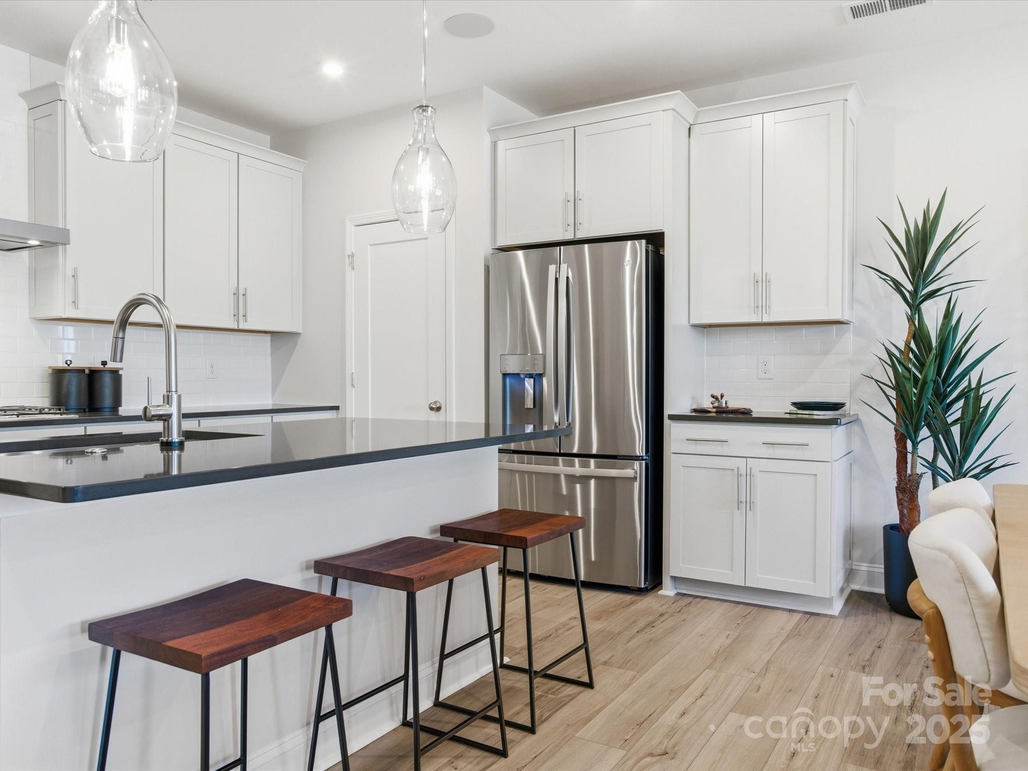 492 Nash Street Fort Mill, SC 29715 - Photo 14 of 28 a kitchen with stainless steel appliances white cabinets and a refrigerator