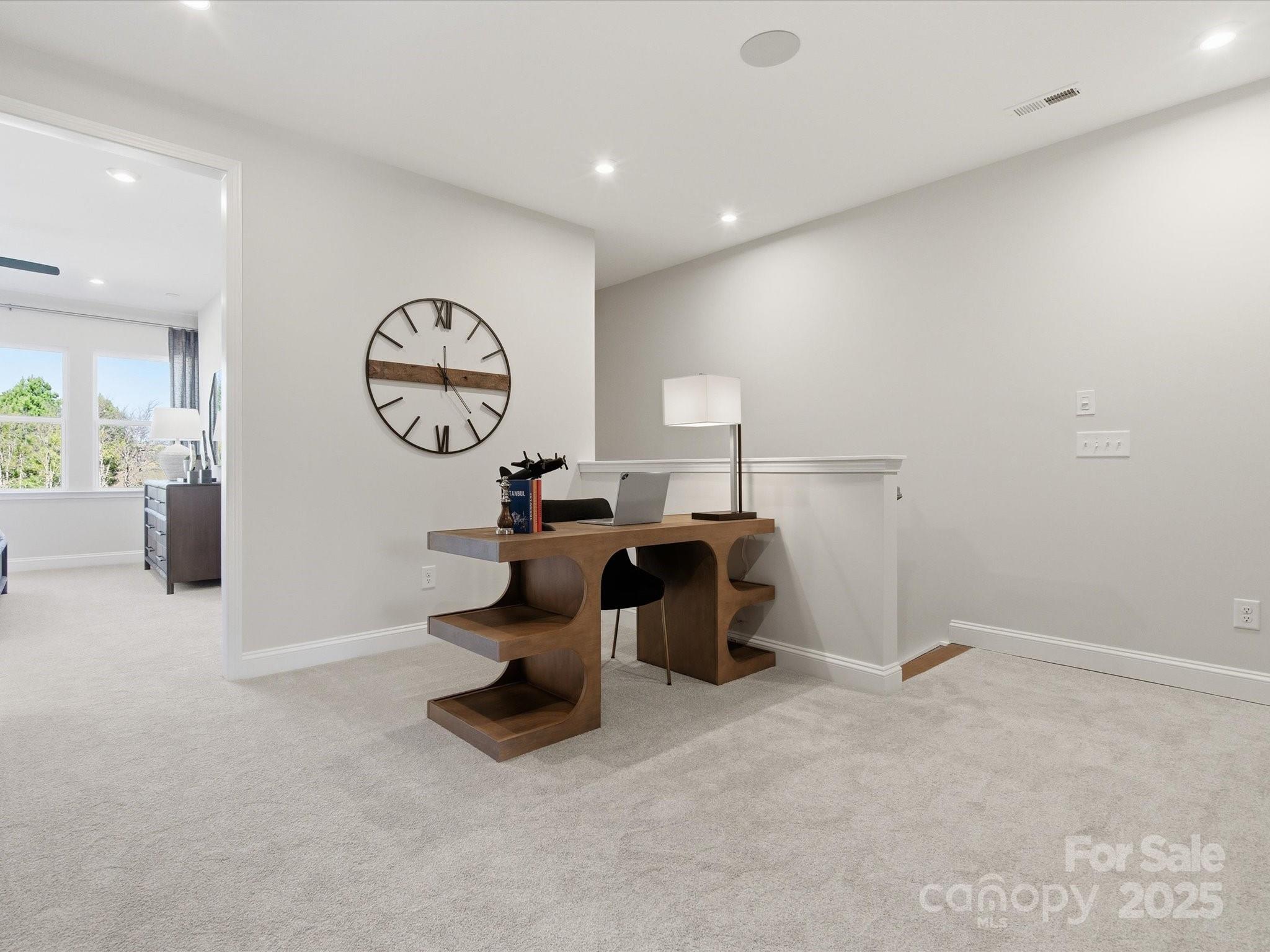 492 Nash Street Fort Mill, SC 29715 - Photo 16 of 28 a living room with furniture a mirror and a clock