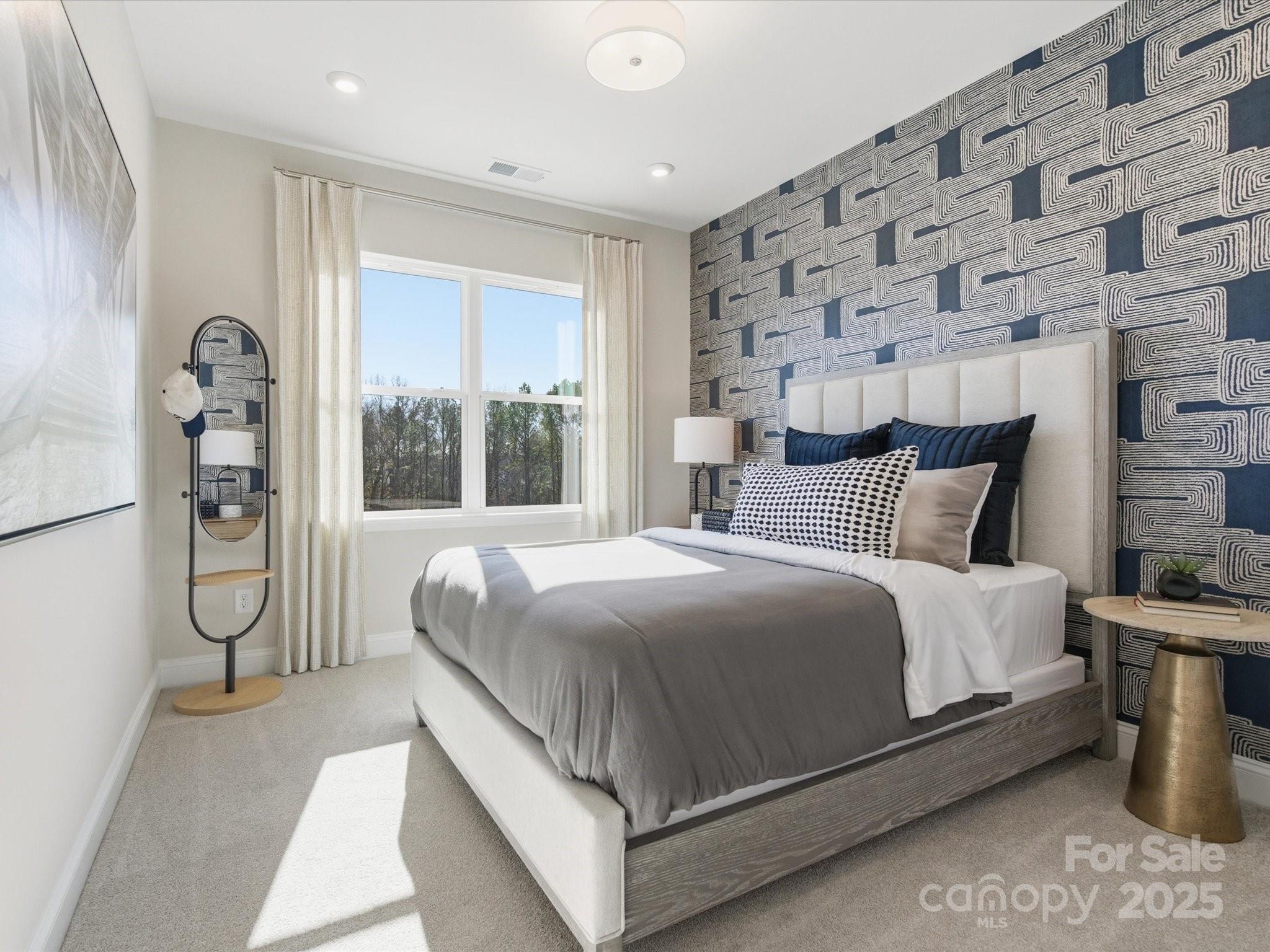 492 Nash Street Fort Mill, SC 29715 - Photo 23 of 28 a bed sitting in a spacious bedroom next to a window and a chair