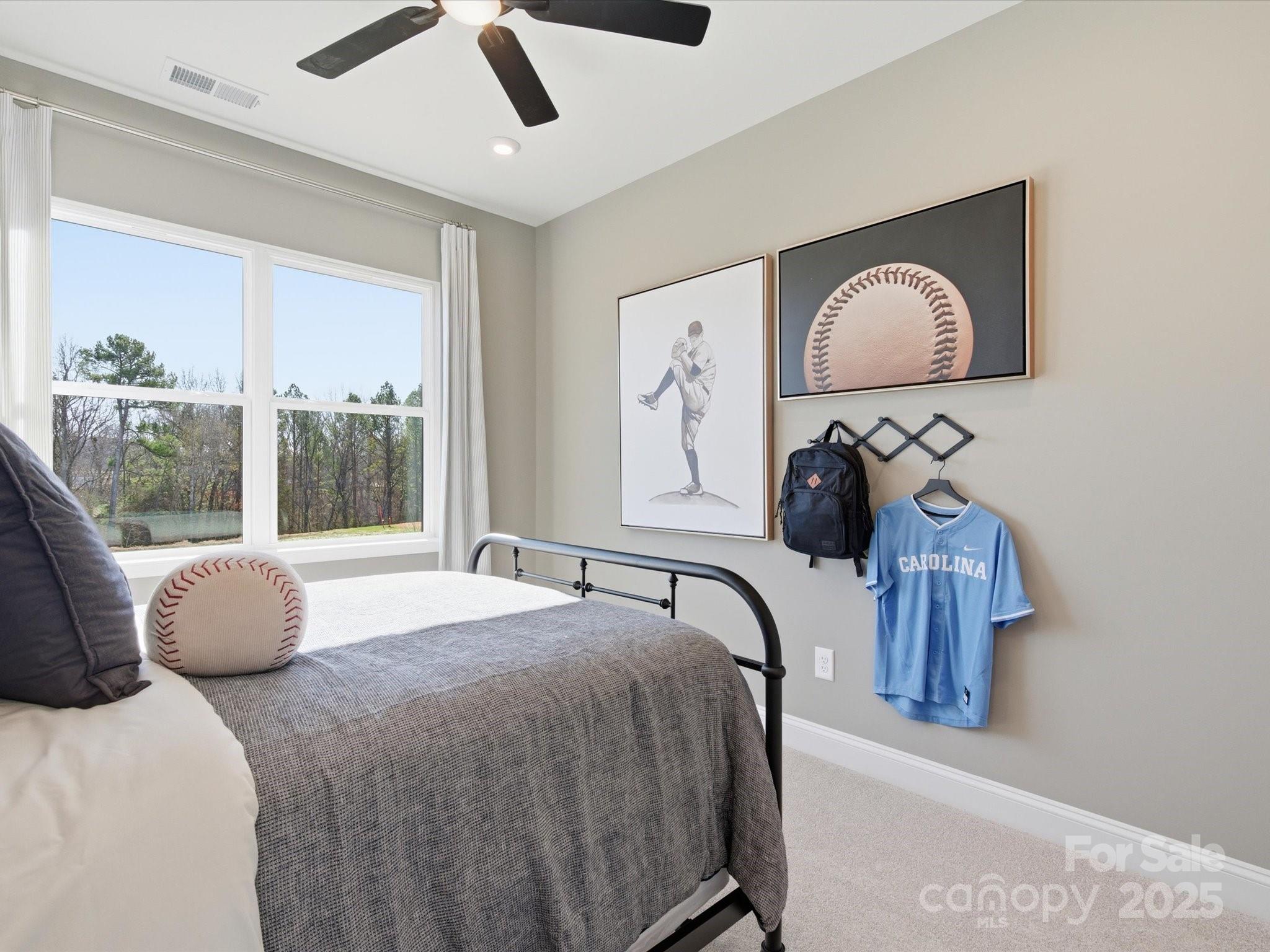 492 Nash Street Fort Mill, SC 29715 - Photo 24 of 28 a bedroom with a bed and dresser with mirror