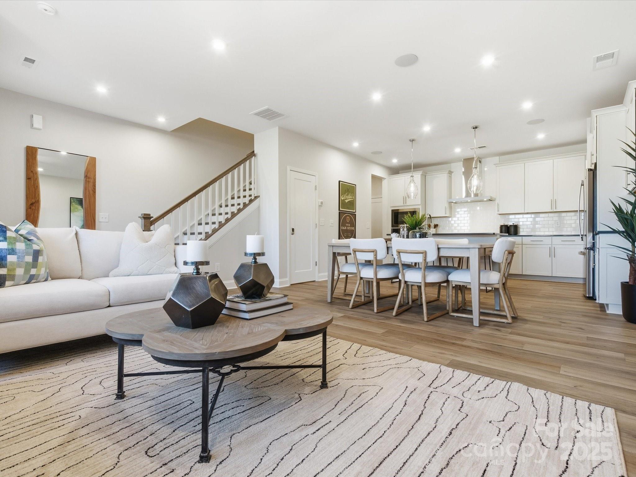 492 Nash Street Fort Mill, SC 29715 - Photo 6 of 28 a living room with stainless steel appliances furniture a rug and a kitchen view