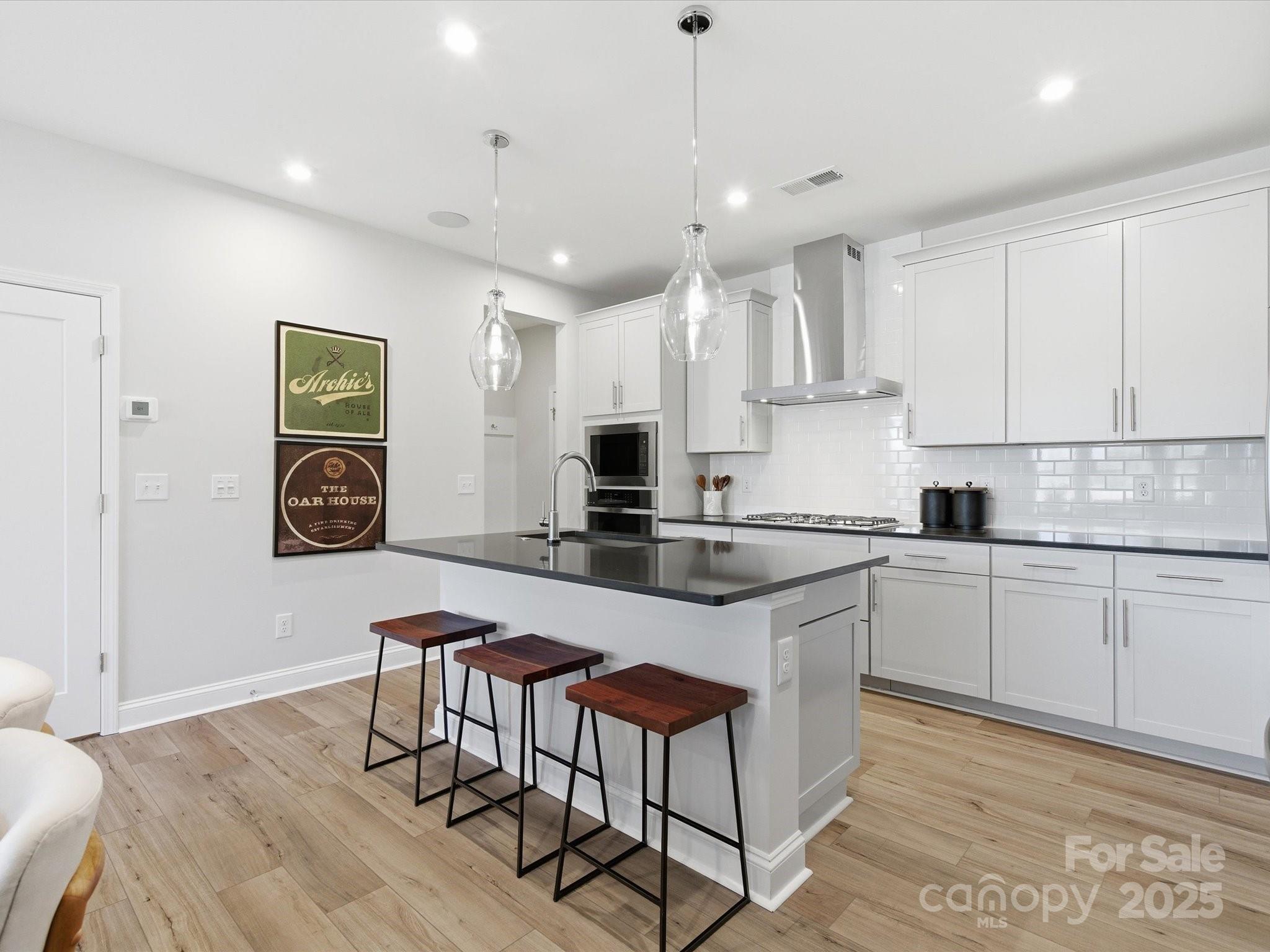 492 Nash Street Fort Mill, SC 29715 - Photo 9 of 28 a kitchen with stainless steel appliances granite countertop a table chairs sink and cabinets