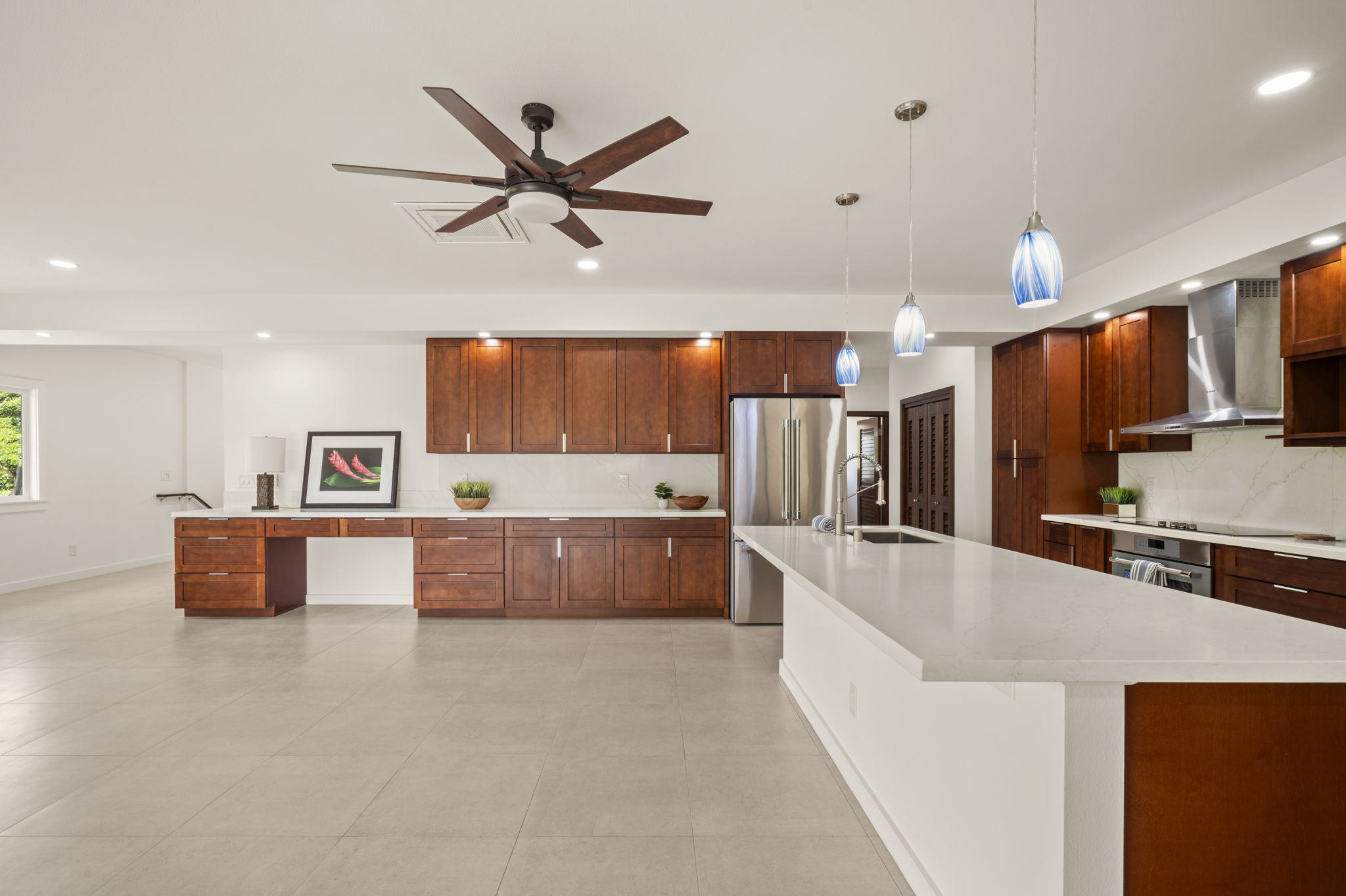 3582 Rice Street Lihue, HI 96766 - Photo 12 of 30 a large kitchen with stainless steel appliances a large counter top a sink a stove and a refrigerator
