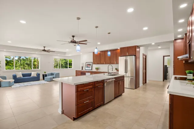 a large kitchen with stainless steel appliances lots of counter top space