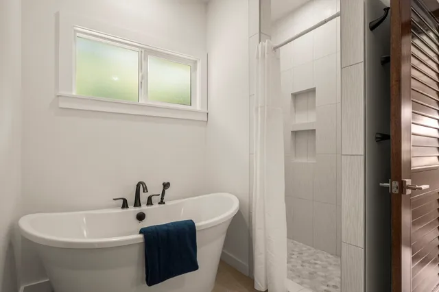 a white bath tub sitting next to a white sink
