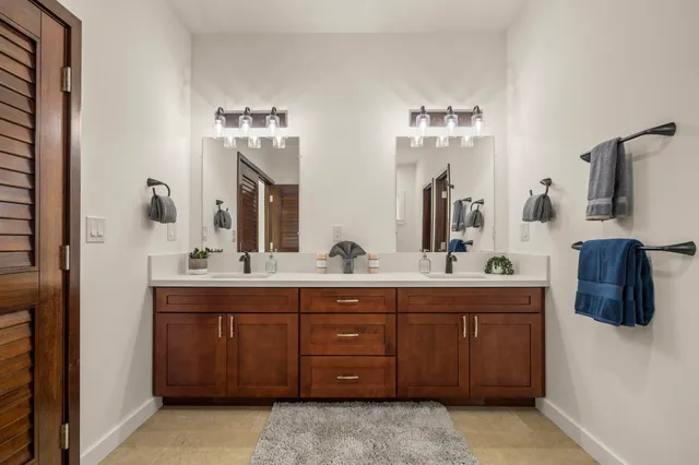 a bathroom with a double vanity sink and a mirror