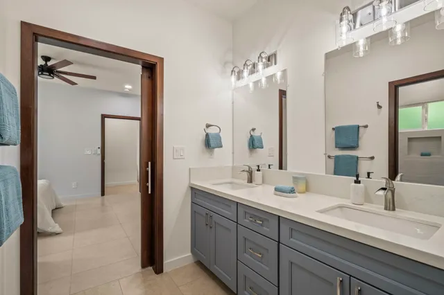 a bathroom with a double vanity sink and a mirror