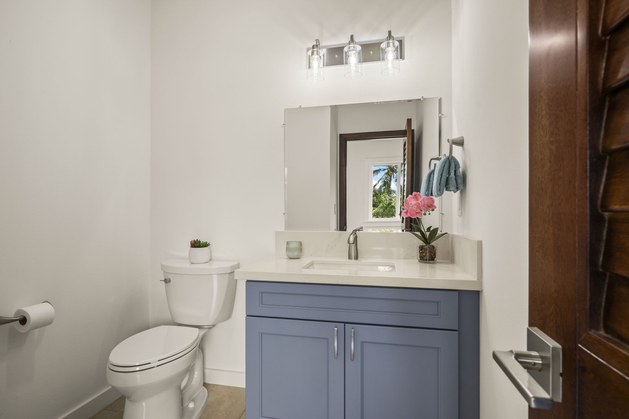 3582 Rice Street Lihue, HI 96766 - Photo 27 of 30 a bathroom with a toilet sink and mirror