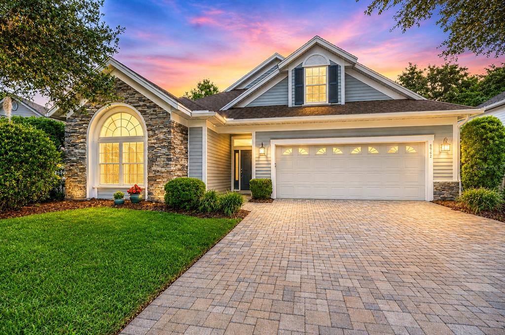 a front view of a house with a yard and garage