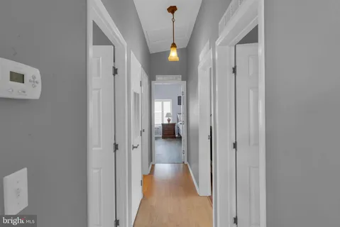 a view of a hallway with wooden shelves