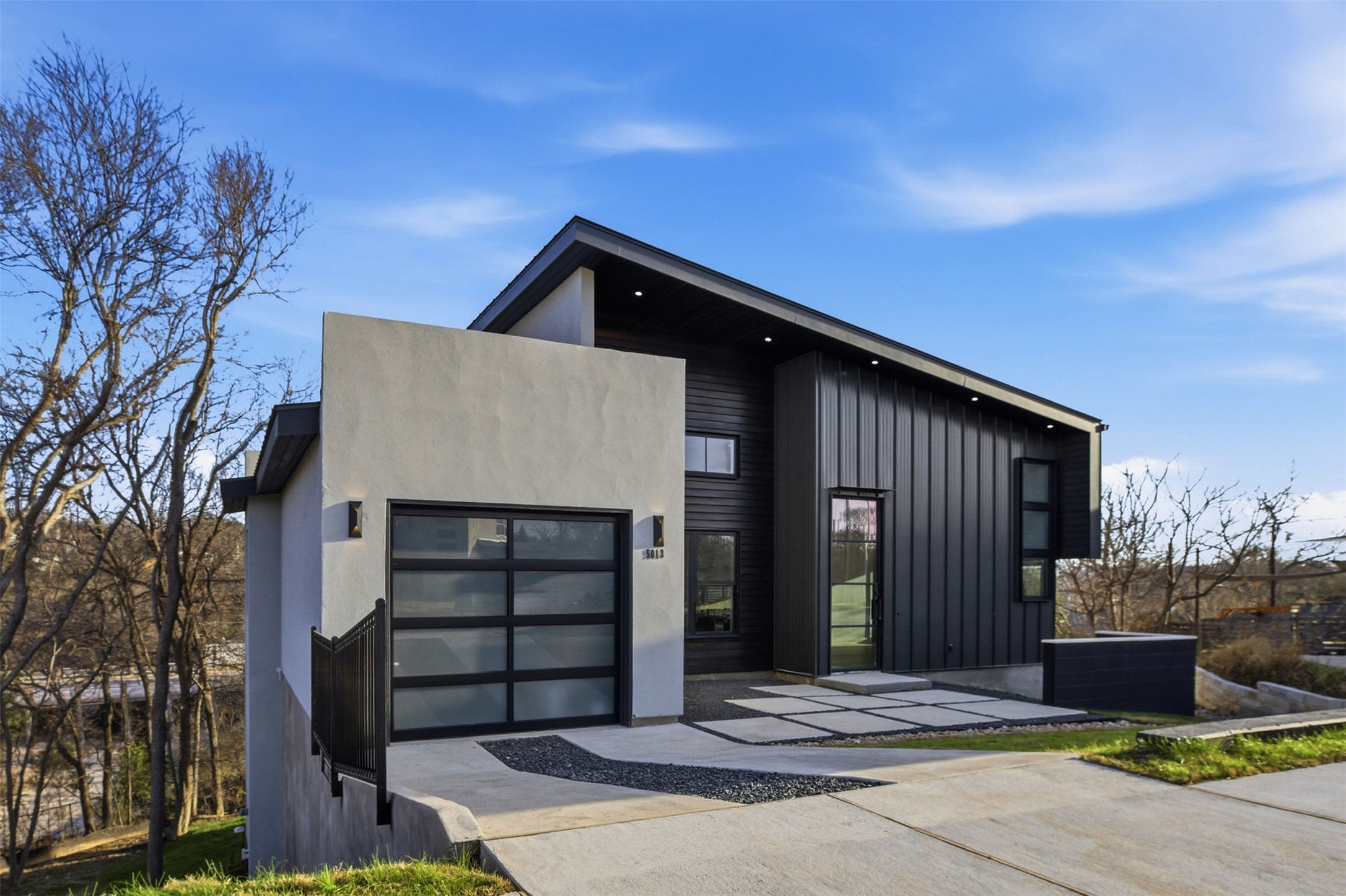 5013 Rob-Scott Street Austin, TX 78721 - Photo 3 of 35 Modern home with an attached garage and concrete driveway.