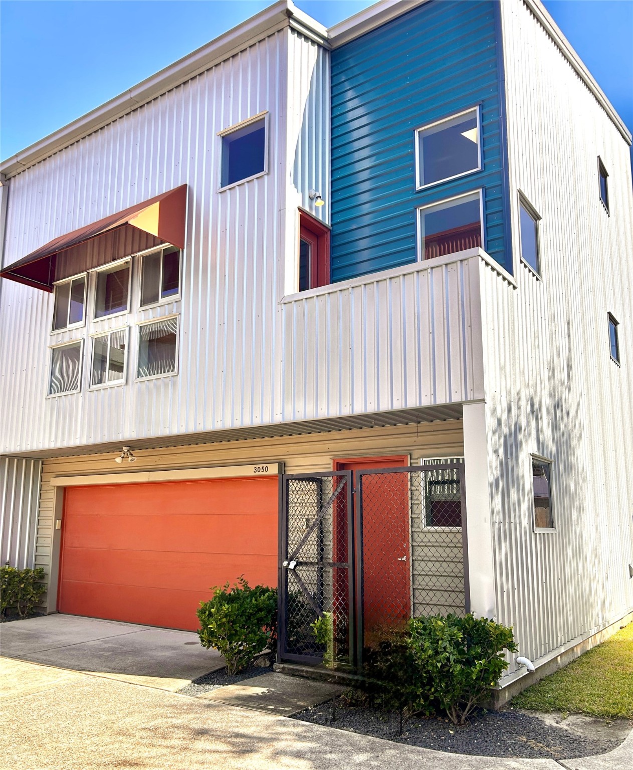 a front view of a house with plants